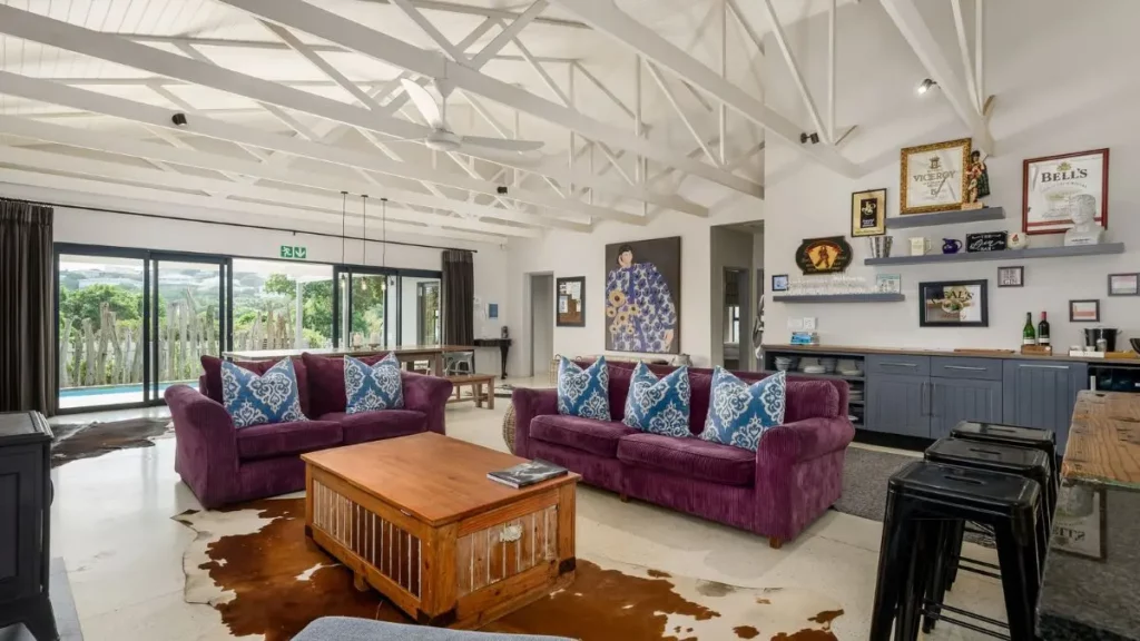 image of a living room with exposed roof trusses and plush furnishing