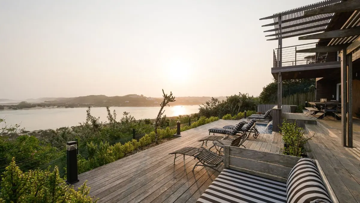 wooden deck with loungers overlooking the beach