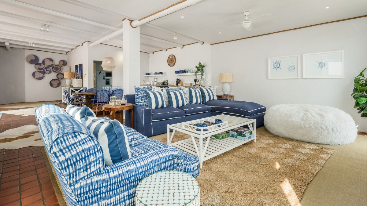 a living room with blue sofas