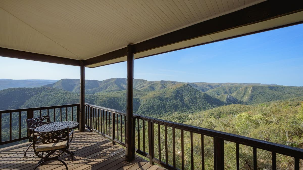 a wooden balcony with a view over mountains