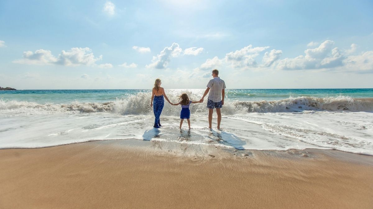 family walking into the sea