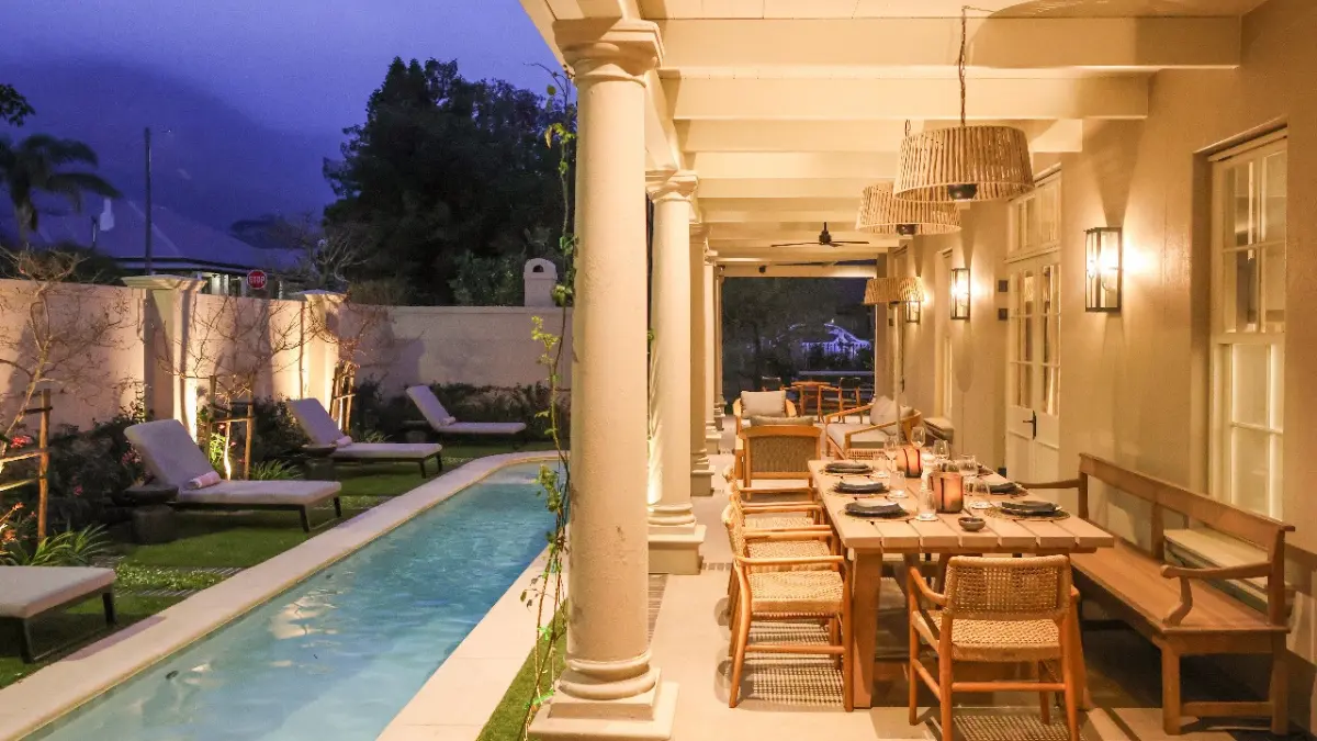 a swimming pool and patio at a luxury villa in Franschhoek