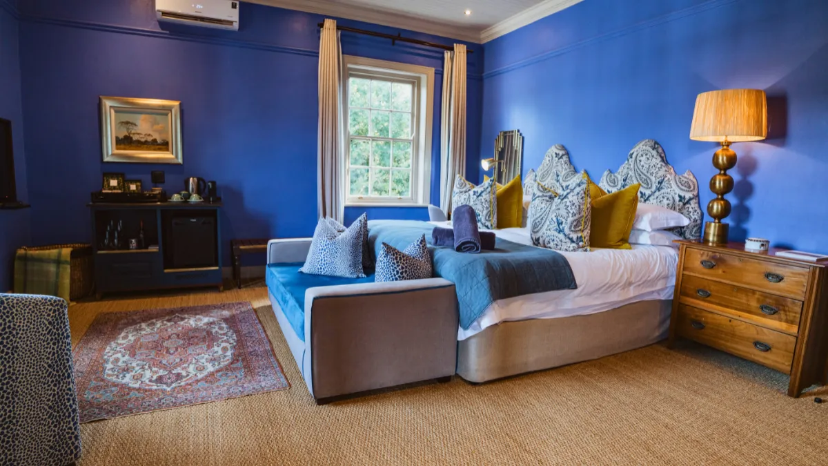 a luxury room with blue walls in a boutique hotel