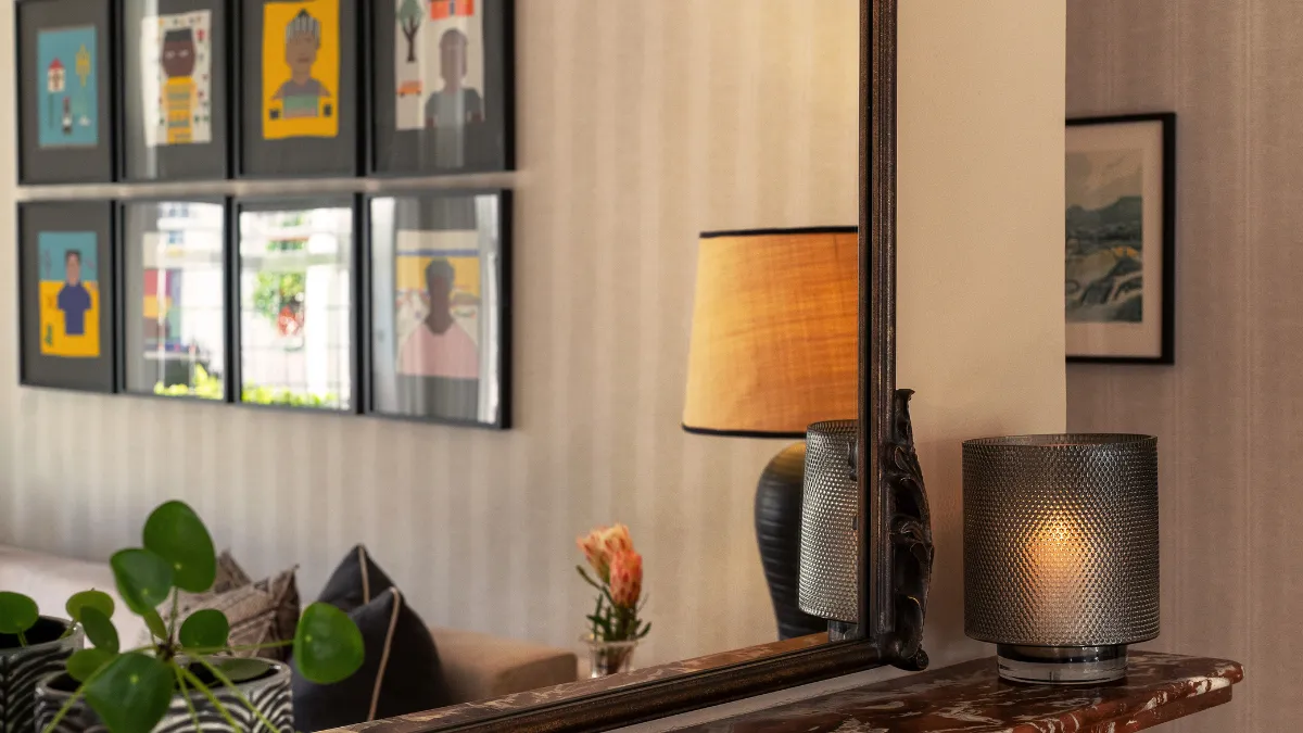 close up of a luxury interior with a lamp and prints on the wall