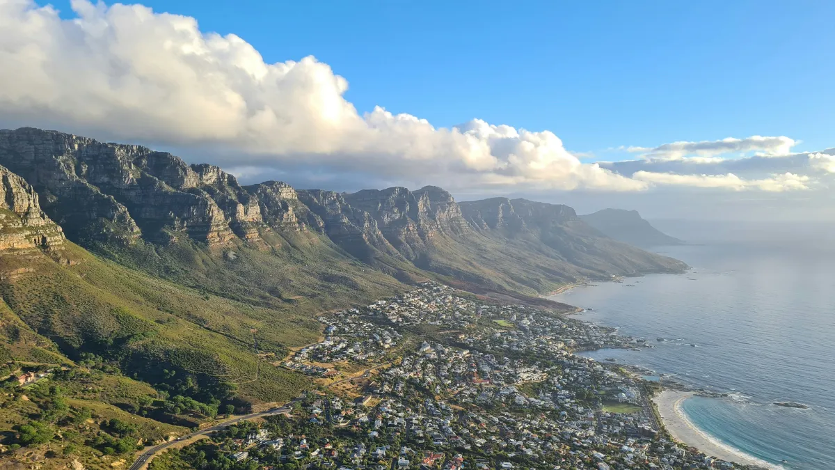 aerial photo of the twelve apostle mountains and camps bay below