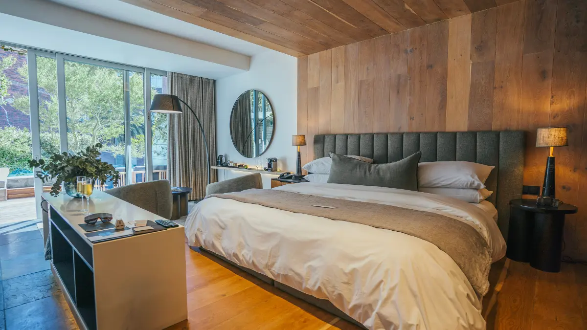 luxury room with wood paneling and a large bed