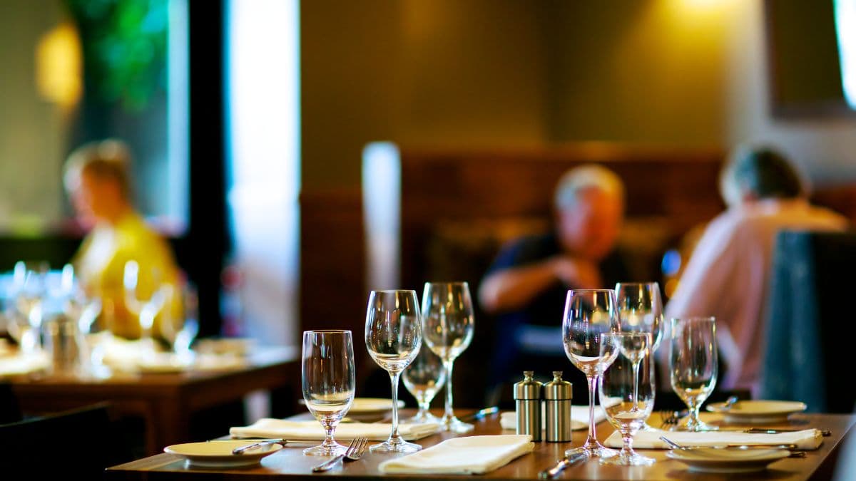 a set table with wine glasses in a restaurant