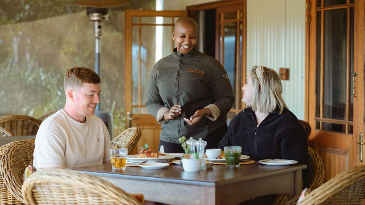 a couple sitting at a table enjoying a meal 