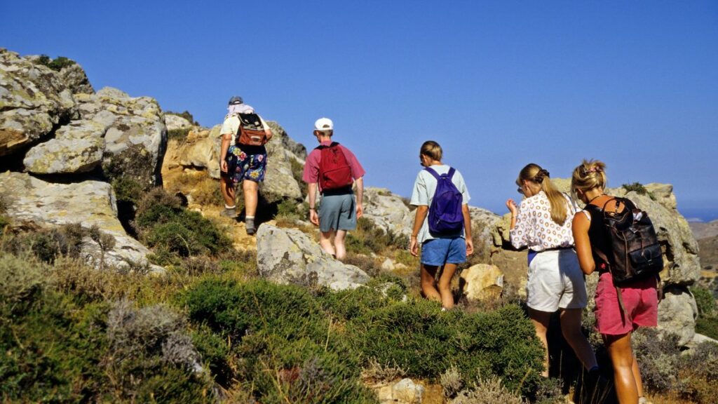 a group of people hiking up a rocky hillside