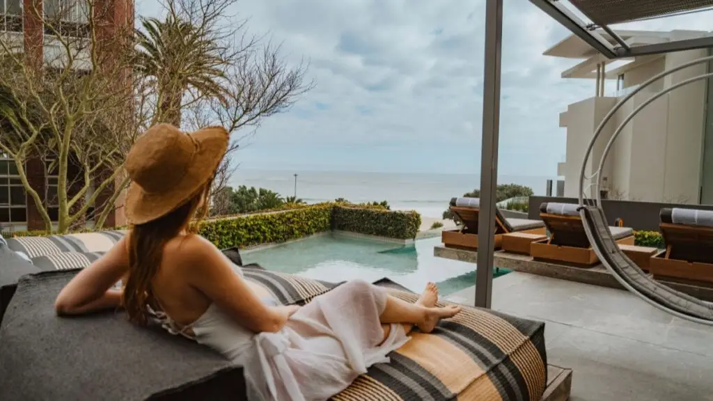 a woman relaxing on the sun deck at POD Camps Bay