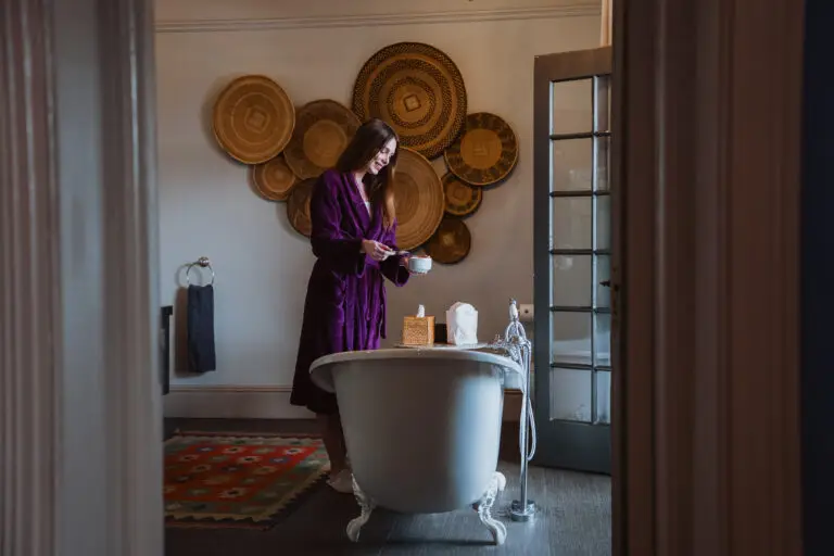 a woman preparing to soak in a slipper bath