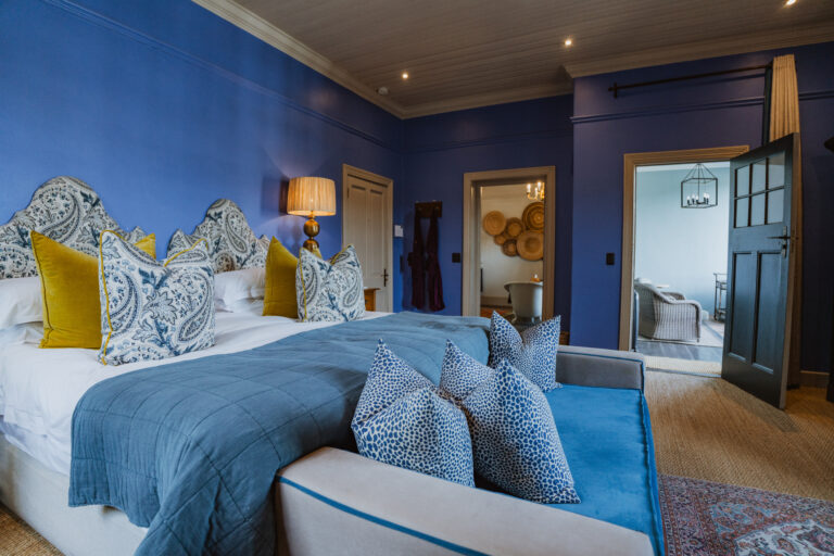 a luxurious blue suite at La Fontaine Boutique Hotel