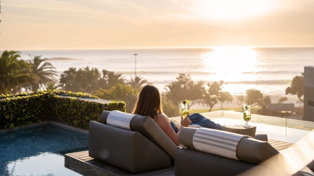 guest relaxing next to the pool at POD camps Bay